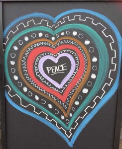 peace written inside a heart drawn on a chalkboard - warming up to change - action institute of california - action insights blog by Jean Campbell