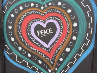 peace written inside a heart drawn on a chalkboard - warming up to change - action institute of california - action insights blog by Jean Campbell