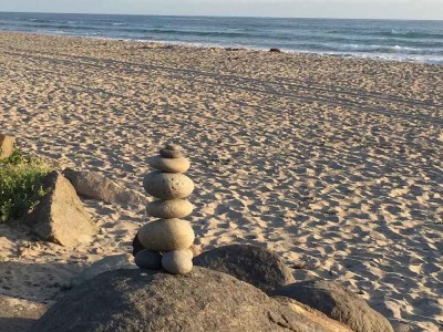 photo of rocks stacked on rocks on a beach - the business of recovery - action institute of california - jean campbell - action insights blog - psychodrama training institute in san diego california