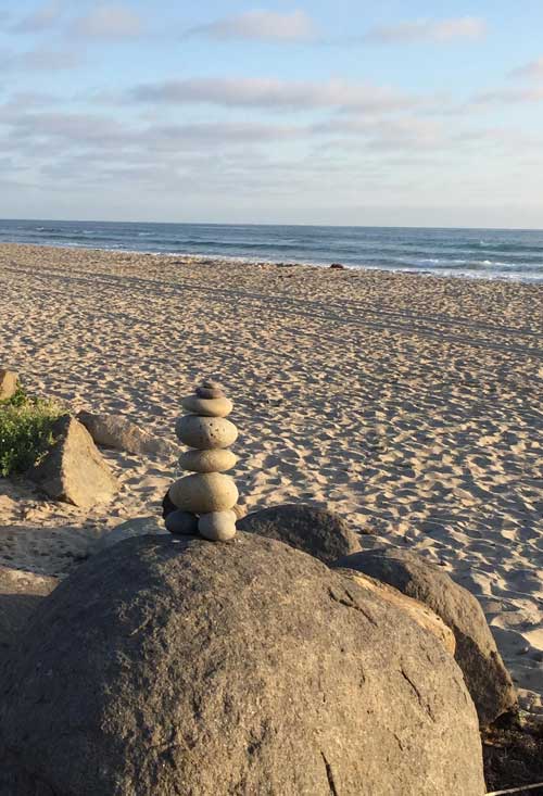 photo of rocks stacked on rocks on a beach - the business of recovery - action institute of california - jean campbell - action insights blog - psychodrama training institute in san diego california