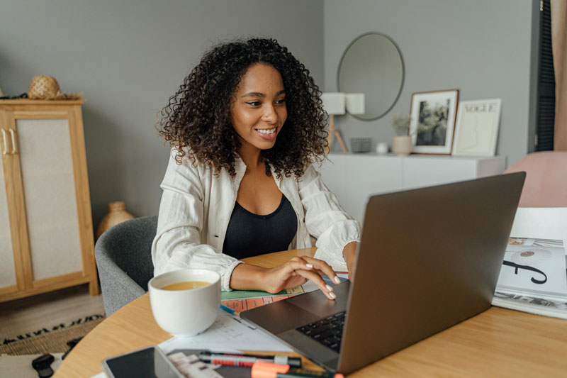 woman sitting at a desk taking an online course - online psychodrama CE courses